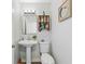 Small half bathroom with pedestal sink and stylish decor at 13822 Judy Ave, Hudson, FL 34667