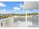 White deck overlooking waterfront with partial view of canal and neighboring houses at 13822 Judy Ave, Hudson, FL 34667