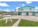 Two story teal home with waterfront access, double garage, and patio at 13822 Judy Ave, Hudson, FL 34667