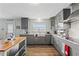 Modern kitchen with gray cabinets, white subway tile, and stainless steel appliances at 13822 Judy Ave, Hudson, FL 34667