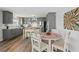 Modern kitchen with gray cabinets, an island, and a breakfast nook at 13822 Judy Ave, Hudson, FL 34667