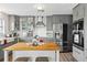 Modern kitchen with gray cabinets, stainless steel appliances, and an island at 13822 Judy Ave, Hudson, FL 34667