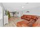 Spacious living room with a large sectional sofa and access to kitchen at 13822 Judy Ave, Hudson, FL 34667