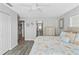 Main bedroom with king bed, en-suite bathroom, and access to kitchen at 13822 Judy Ave, Hudson, FL 34667