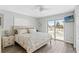 Bright bedroom with a king-size bed and private balcony access at 13822 Judy Ave, Hudson, FL 34667