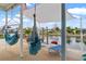 Waterfront patio features a hammock and lounge chairs under a shade sail at 13822 Judy Ave, Hudson, FL 34667