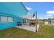 Concrete patio with shaded picnic table and bench, near waterfront at 13822 Judy Ave, Hudson, FL 34667