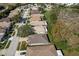 Aerial view showcasing a neighborhood's homes and surrounding green space at 14120 Whitecap Ave, Hudson, FL 34667