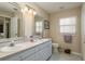Bathroom with double vanity and large mirror at 14120 Whitecap Ave, Hudson, FL 34667