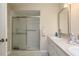 Bathroom with double vanity, shower, and linen closet at 14120 Whitecap Ave, Hudson, FL 34667