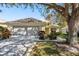 House exterior showcasing a screened garage and well maintained landscaping at 14120 Whitecap Ave, Hudson, FL 34667