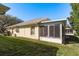 Well-maintained house exterior with screened enclosure at 14120 Whitecap Ave, Hudson, FL 34667