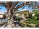 Single-story house with landscaped yard and large oak tree at 14120 Whitecap Ave, Hudson, FL 34667