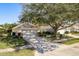 Single-story house with attached garage and mature tree at 14120 Whitecap Ave, Hudson, FL 34667