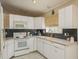 Bright kitchen with white cabinets, and modern appliances at 14120 Whitecap Ave, Hudson, FL 34667