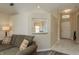 Living room with view into kitchen and access to hallway at 14120 Whitecap Ave, Hudson, FL 34667