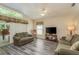 Bright living room with vaulted ceilings, ceiling fan, neutral walls, wood-look floors, and comfortable couches at 14120 Whitecap Ave, Hudson, FL 34667
