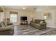 Living room with two sofas, a rocking chair, and a large screen TV at 14120 Whitecap Ave, Hudson, FL 34667