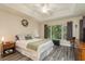 Spacious main bedroom with wood-look floors and large window at 14120 Whitecap Ave, Hudson, FL 34667