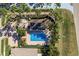 Top-down view of a community pool with surrounding landscaping and patio at 14120 Whitecap Ave, Hudson, FL 34667