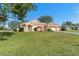 Single-story house with a two-car garage and a large front yard at 15111 Traverse Ln, Brooksville, FL 34604