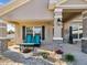 Charming front porch with teal chairs and flower pots, creating a welcoming entrance at 3277 Ponytail Ct, Spring Hill, FL 34609