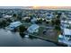 Waterfront property with two-story house and boat; sunset view at 3340 Oleander Dr, Hernando Beach, FL 34607