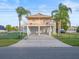 Two-story house with attached garage, waterfront view, and palm trees at 3340 Oleander Dr, Hernando Beach, FL 34607