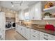White kitchen cabinets, granite countertops, and laundry area at 3340 Oleander Dr, Hernando Beach, FL 34607