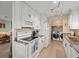 White kitchen cabinets, granite countertops, and laundry area at 3340 Oleander Dr, Hernando Beach, FL 34607
