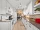 White kitchen cabinets, granite countertops, and laundry area at 3340 Oleander Dr, Hernando Beach, FL 34607