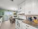 White kitchen with granite counters, island, and water views at 3340 Oleander Dr, Hernando Beach, FL 34607