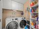 Laundry room with washer, dryer, and storage shelves at 3340 Oleander Dr, Hernando Beach, FL 34607
