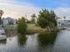 Vacant waterfront lot with lush landscaping, canal view at 3340 Oleander Dr, Hernando Beach, FL 34607