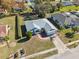 Aerial view of single-story house, paved driveway and neighborhood at 3470 Cedar Crest Loop, Spring Hill, FL 34609