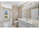 Bathroom features a single sink vanity, bathtub, and a window at 3470 Cedar Crest Loop, Spring Hill, FL 34609