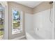 Bathroom with a shower/tub combo and a window overlooking the backyard at 3470 Cedar Crest Loop, Spring Hill, FL 34609