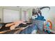 bedroom with dinosaur mural, built-in dresser, and ample closet space at 3470 Cedar Crest Loop, Spring Hill, FL 34609