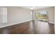 Spacious bedroom with dark wood-look tile flooring and backyard access at 3470 Cedar Crest Loop, Spring Hill, FL 34609
