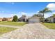 Single-story home with gray exterior and a paved driveway at 3470 Cedar Crest Loop, Spring Hill, FL 34609