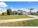 Single story home with gray exterior and a paved driveway at 3470 Cedar Crest Loop, Spring Hill, FL 34609