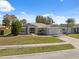 Single-story home with gray exterior and a paved driveway at 3470 Cedar Crest Loop, Spring Hill, FL 34609