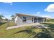 House exterior showcasing a screened patio and backyard at 3470 Cedar Crest Loop, Spring Hill, FL 34609