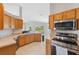 Kitchen boasts wood cabinets, stainless steel appliances, and ample counter space at 3470 Cedar Crest Loop, Spring Hill, FL 34609
