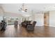 Spacious living room with tile floors, a ceiling fan, and sliding glass doors at 3470 Cedar Crest Loop, Spring Hill, FL 34609