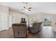 Living area featuring hardwood floors, a ceiling fan, and access to the backyard at 3470 Cedar Crest Loop, Spring Hill, FL 34609