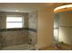 Updated bathroom with a bathtub, shower, and modern vanity at 3518 Moog Rd, Holiday, FL 34691