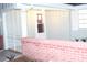 Front entrance with brick wall and wrought iron gate at 3518 Moog Rd, Holiday, FL 34691