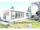 Single story home with large windows and a deck at 3518 Moog Rd, Holiday, FL 34691