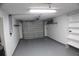 Garage with shelving and automatic garage door at 3518 Moog Rd, Holiday, FL 34691